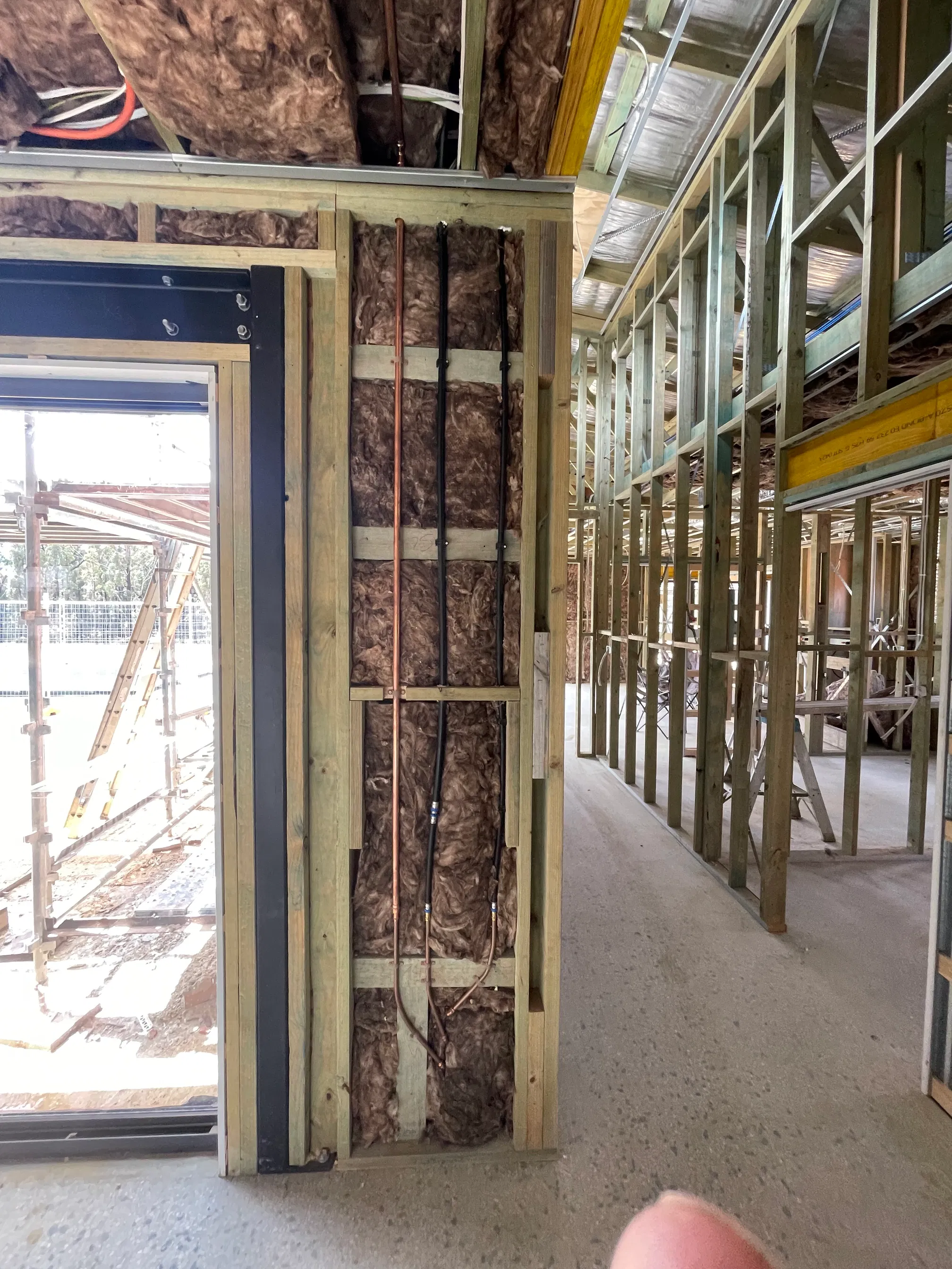 Copper and insulated pipe rough-in through timber framing and insulation
